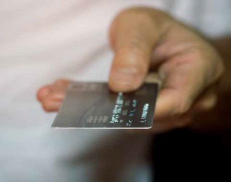 Close up of hand with a credit card.