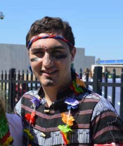 Young man in head band with face painting.