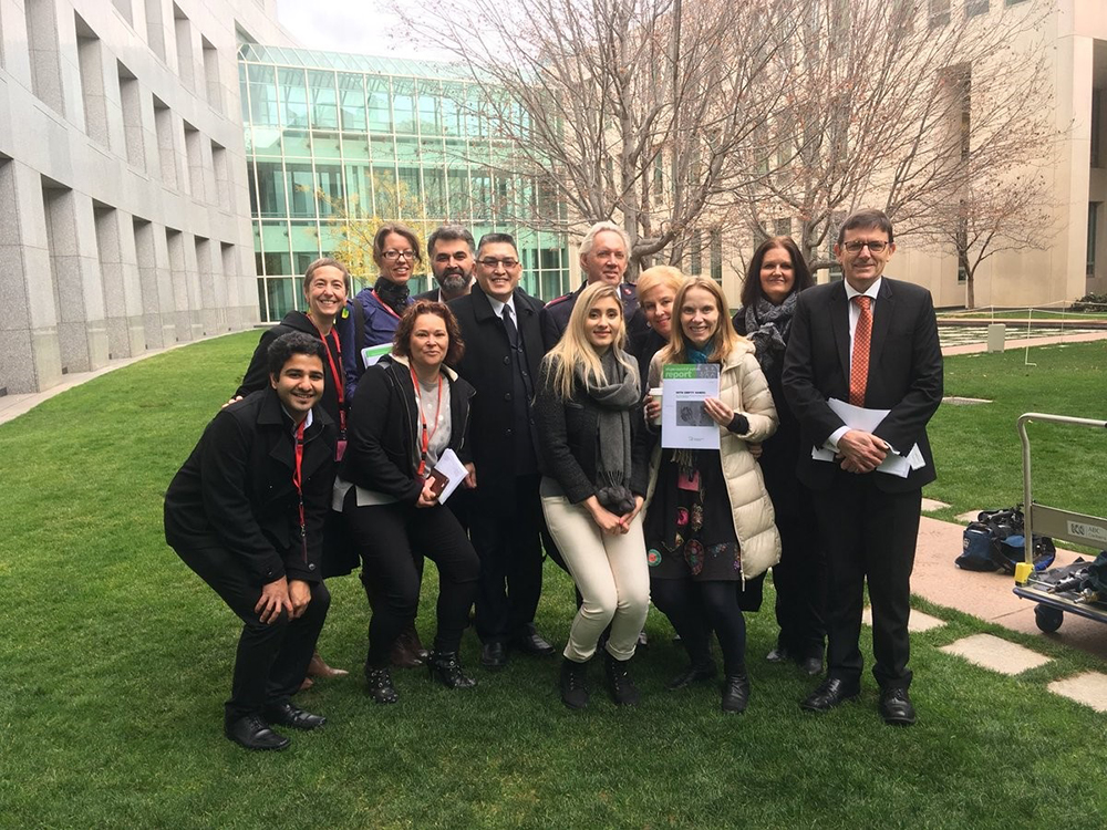 Group posed in a court yard of Parliament House.